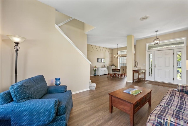 1840 Nashville Ln, Crystal Lake, IL 60014 - living room featuring stairway, wood finished floors, baseboards, and a chandelier