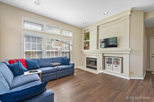 1840 Nashville Ln, Crystal Lake, IL 60014 - living room featuring wood finished floors, built in features, baseboards, a fireplace with flush hearth, and recessed lighting