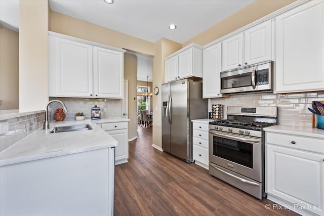 1840 Nashville Ln, Crystal Lake, IL 60014 - kitchen featuring stainless steel appliances, a sink, white cabinetry, tasteful backsplash, and recessed lighting