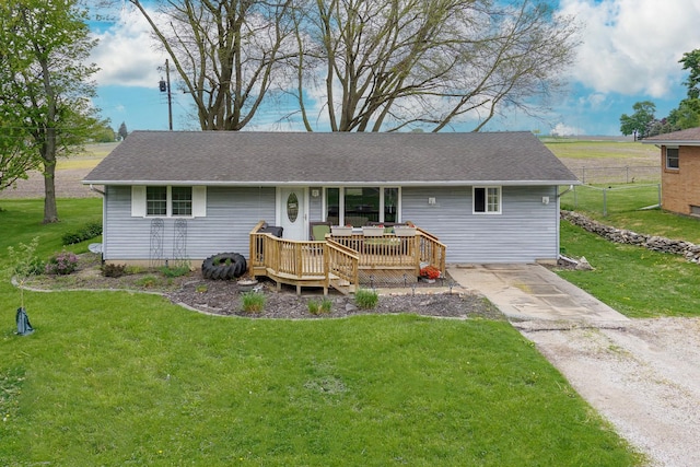 view of front of property with a deck, roof with shingles, and driveway