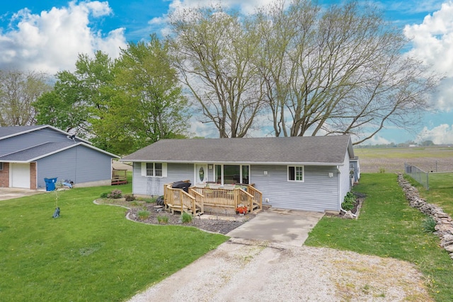 view of front of property featuring driveway and a wooden deck