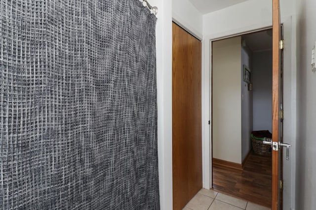 corridor featuring light tile patterned floors