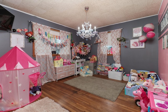 bedroom with a chandelier, wood finished floors, and crown molding