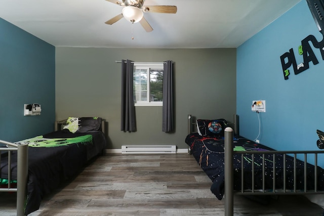bedroom with a baseboard heating unit, wood finished floors, and ceiling fan