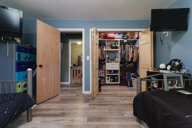 bedroom with light wood-style floors and a closet