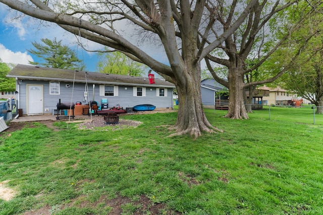 rear view of house featuring an outdoor fire pit and a patio