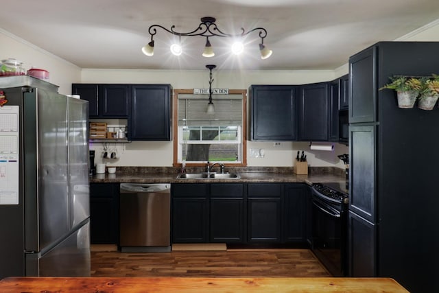 kitchen with black appliances, dark countertops, a sink, crown molding, and dark wood-style flooring