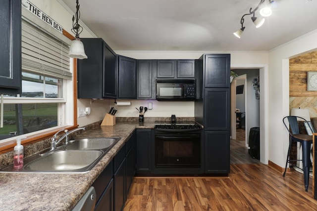 kitchen featuring black appliances, a sink, ornamental molding, dark wood-style floors, and hanging light fixtures