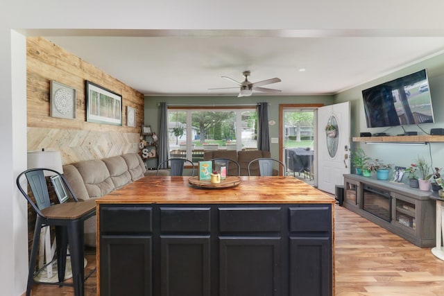 kitchen with wooden counters, plenty of natural light, ceiling fan, and light wood-type flooring