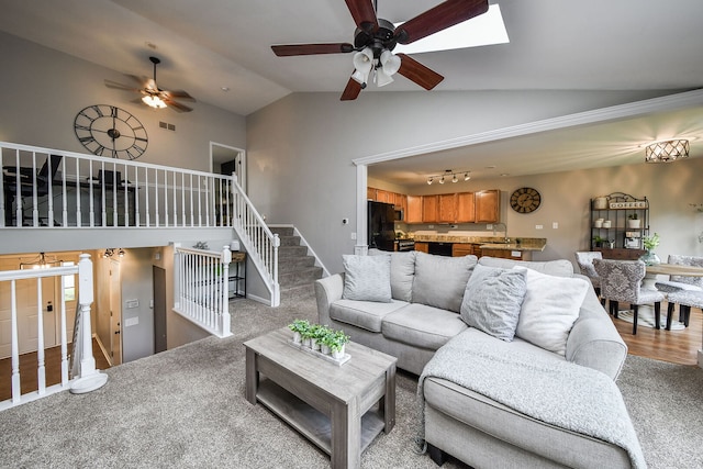 living room featuring a ceiling fan, carpet, and high vaulted ceiling