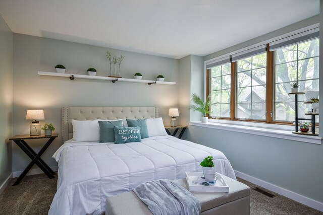 carpeted bedroom featuring baseboards