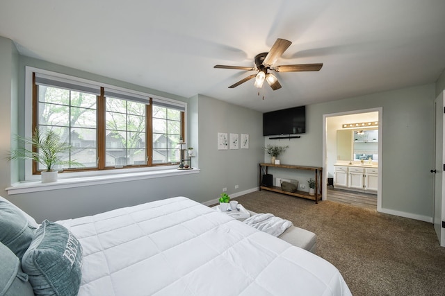 bedroom with carpet, baseboards, ensuite bath, ceiling fan, and a sink