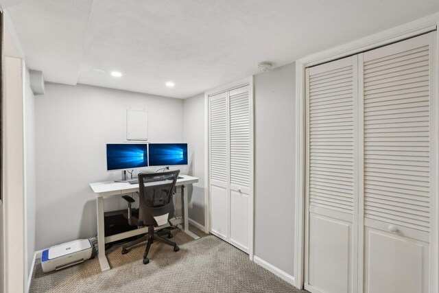 bathroom featuring a shower stall, wood finished floors, toilet, baseboards, and double vanity