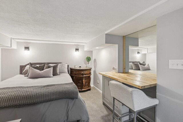 carpeted bedroom featuring baseboards and recessed lighting