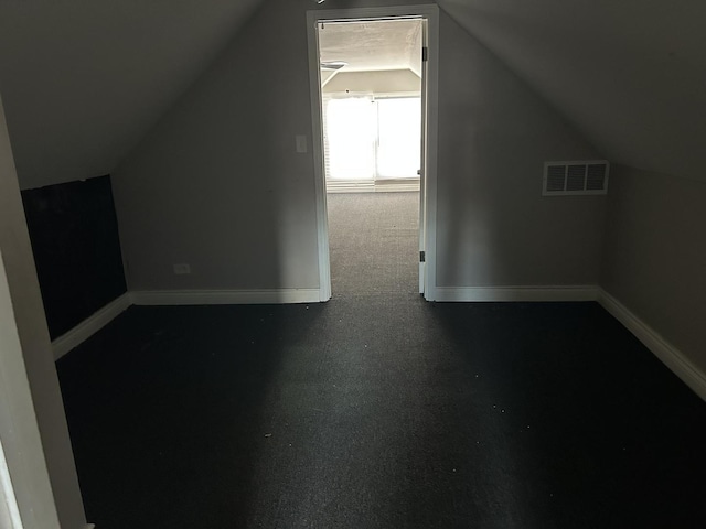 bonus room with lofted ceiling, baseboards, and visible vents