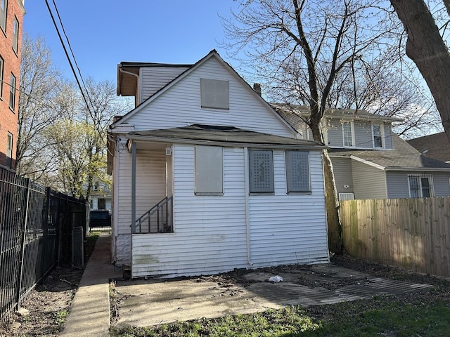 back of property featuring fence