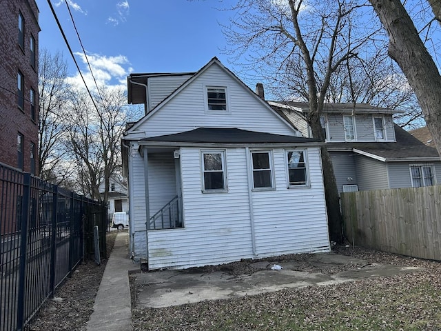 rear view of house with fence