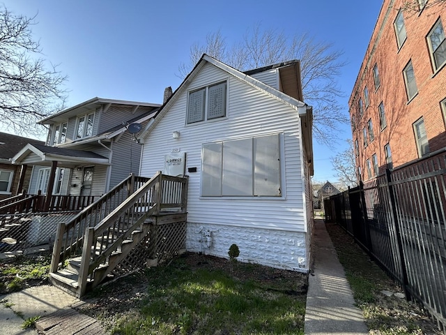 rear view of property with fence and a chimney