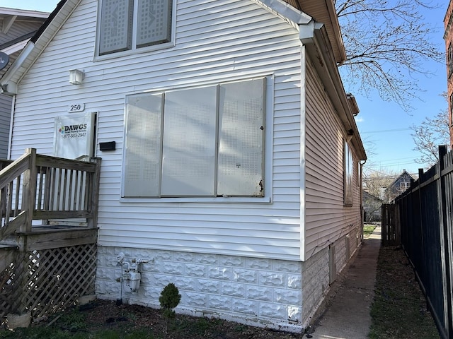 view of side of home with fence