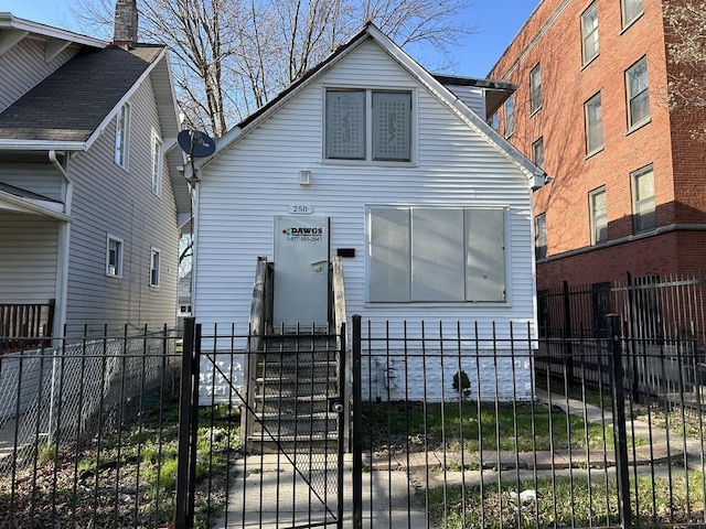 view of front of home featuring a fenced front yard and a gate