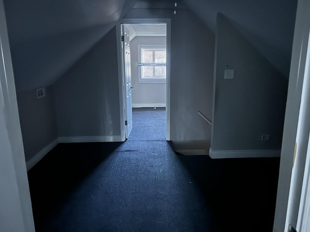 bonus room with vaulted ceiling and baseboards