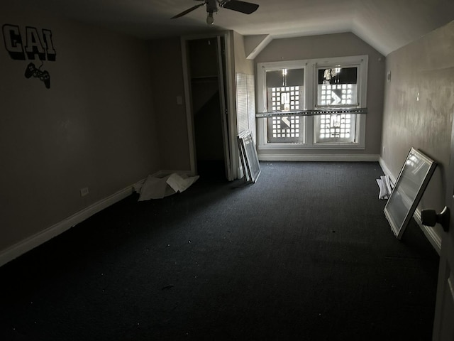 unfurnished room featuring ceiling fan, lofted ceiling, carpet flooring, and baseboards