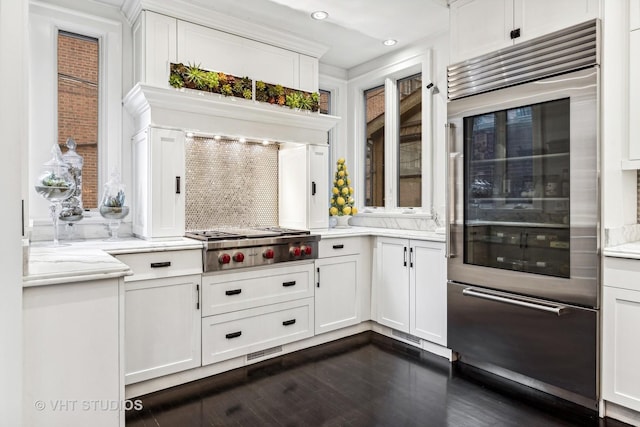 kitchen with white cabinetry, dark wood-style flooring, appliances with stainless steel finishes, decorative backsplash, and recessed lighting