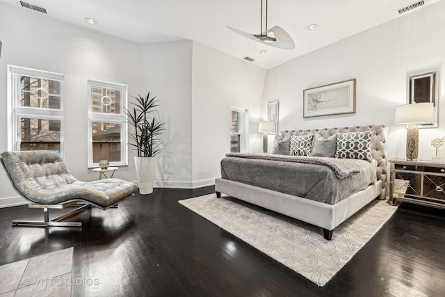 bedroom featuring baseboards, visible vents, and wood finished floors