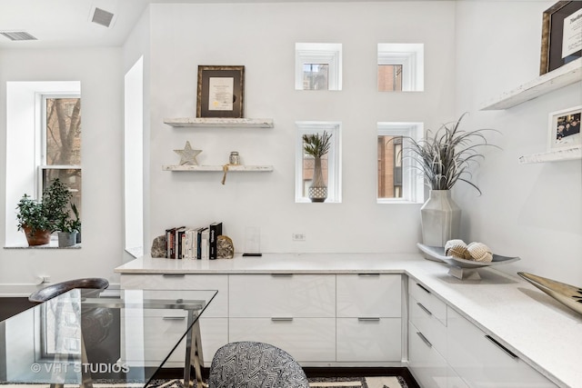 interior space featuring visible vents and a healthy amount of sunlight
