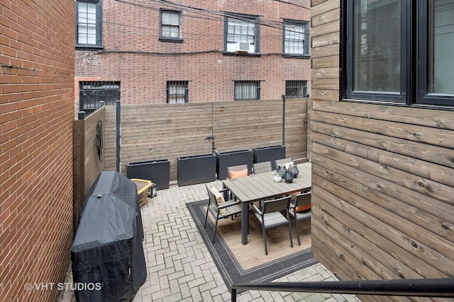 view of patio / terrace featuring a fenced backyard, outdoor dining area, a grill, and cooling unit
