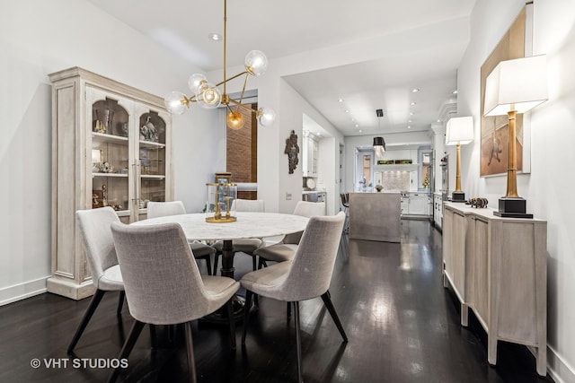 dining area featuring a notable chandelier, recessed lighting, and dark wood-type flooring