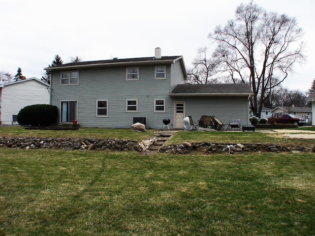 571 Dawn Cir, Grayslake, IL 60030 - rear view of house featuring a chimney and a lawn