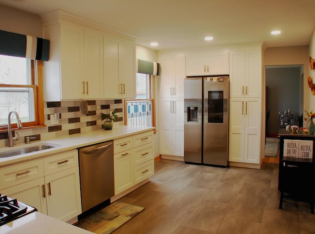 571 Dawn Cir, Grayslake, IL 60030 - kitchen featuring a sink, backsplash, light countertops, and appliances with stainless steel finishes