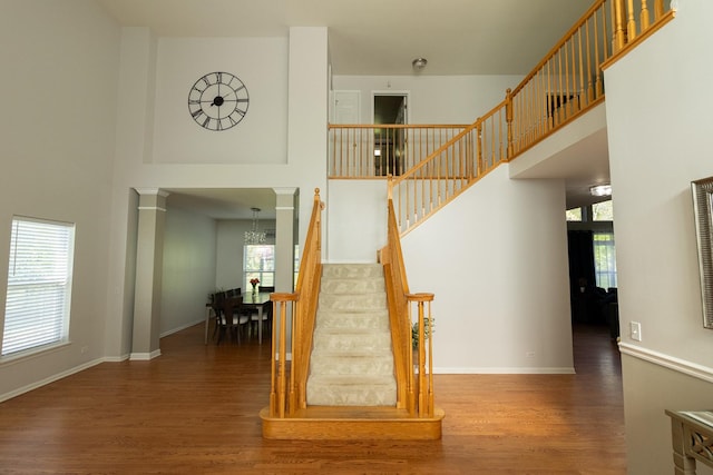 131 Glenbrook Cir, Gilberts, IL 60136 - stairs featuring baseboards, wood finished floors, a towering ceiling, and a notable chandelier