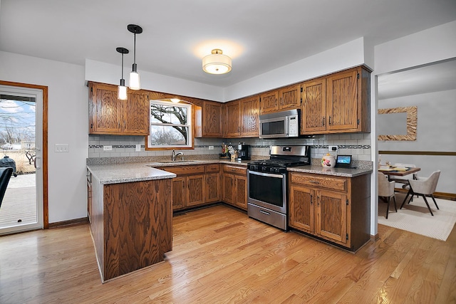 2800 Abbington Dr, New Lenox, IL 60451 - kitchen with light wood-type flooring, appliances with stainless steel finishes, tasteful backsplash, and a sink