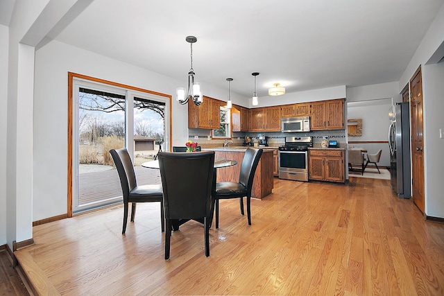 2800 Abbington Dr, New Lenox, IL 60451 - dining room with light wood-style floors, baseboards, and a chandelier