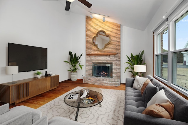 2800 Abbington Dr, New Lenox, IL 60451 - living room with vaulted ceiling, rail lighting, wood finished floors, a ceiling fan, and a fireplace
