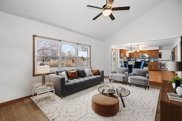 2800 Abbington Dr, New Lenox, IL 60451 - living area with light wood-style flooring, a ceiling fan, high vaulted ceiling, baseboards, and a chandelier