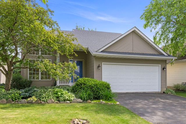 726 Hawthorne Ln, Genoa, IL 60135 - view of front facade featuring asphalt driveway, a front lawn, an attached garage, and roof with shingles