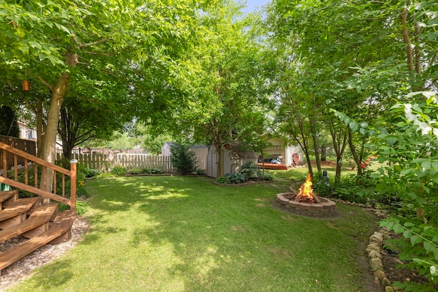726 Hawthorne Ln, Genoa, IL 60135 - fenced backyard with an outdoor fire pit