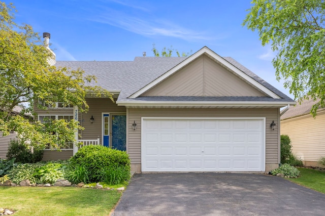 726 Hawthorne Ln, Genoa, IL 60135 - view of front of house featuring driveway, roof with shingles, and an attached garage