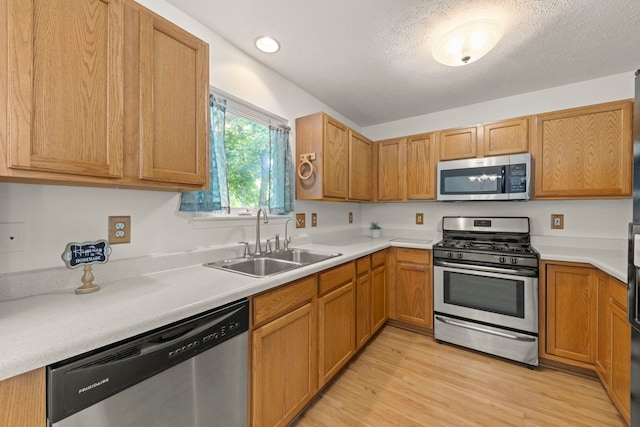 726 Hawthorne Ln, Genoa, IL 60135 - kitchen with stainless steel appliances, light wood-type flooring, light countertops, a textured ceiling, and recessed lighting