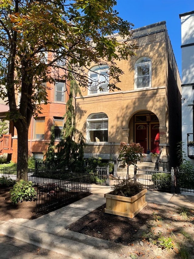 view of front facade with a fenced front yard and a gate