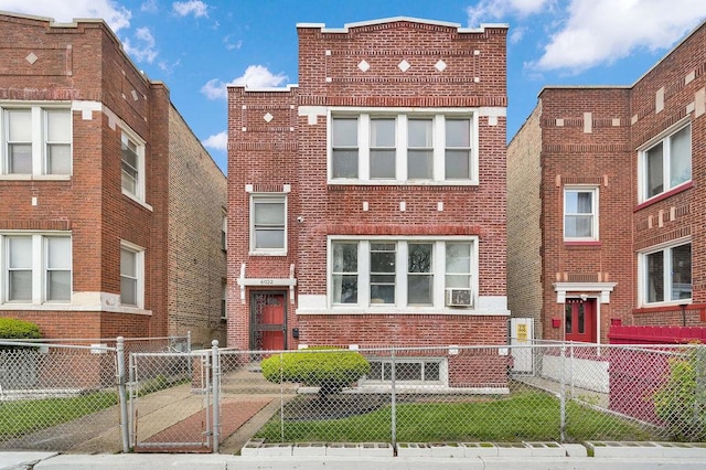 6022 S Artesian Ave, Chicago, IL 60629 - view of front facade with brick siding, a fenced front yard, a gate, and cooling unit