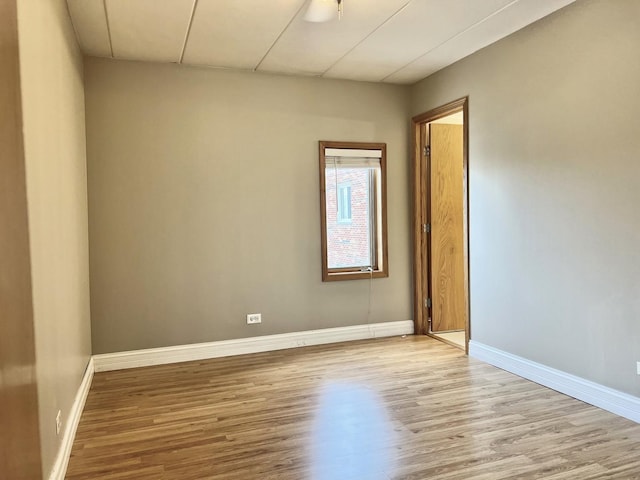 spare room with wood finished floors and baseboards