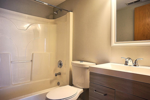 bathroom featuring toilet, shower / washtub combination, and vanity