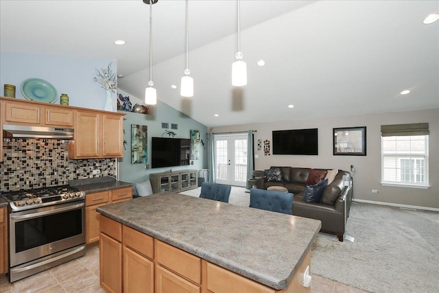 24725 W Hawthorne Dr, Round Lake, IL 60073 - kitchen featuring gas range, under cabinet range hood, a kitchen island, backsplash, and open floor plan
