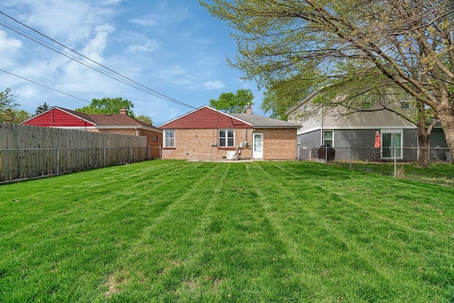 rear view of house with brick siding and a chimney