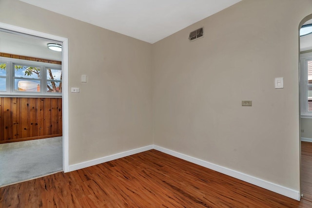 spare room with wood finished floors and baseboards