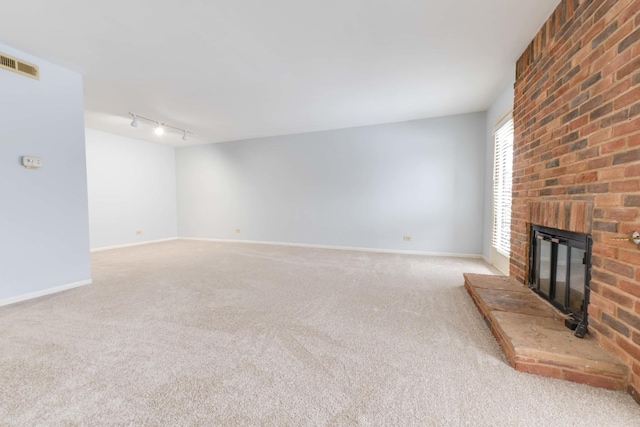 26 Prairie Dr, Westmont, IL 60559 - unfurnished living room with a fireplace, track lighting, carpet floors, and visible vents